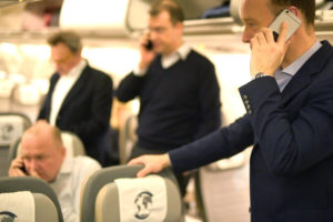 美國擬嚴查身分，要求入境的外國人交出手機。圖為幾名旅客在機上使用手機。p1155-a1-05